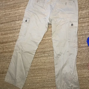 Pants (cargo) - Cream/beige  cargo pants, in a good condition. Available at Skanstull station, Stockholm.