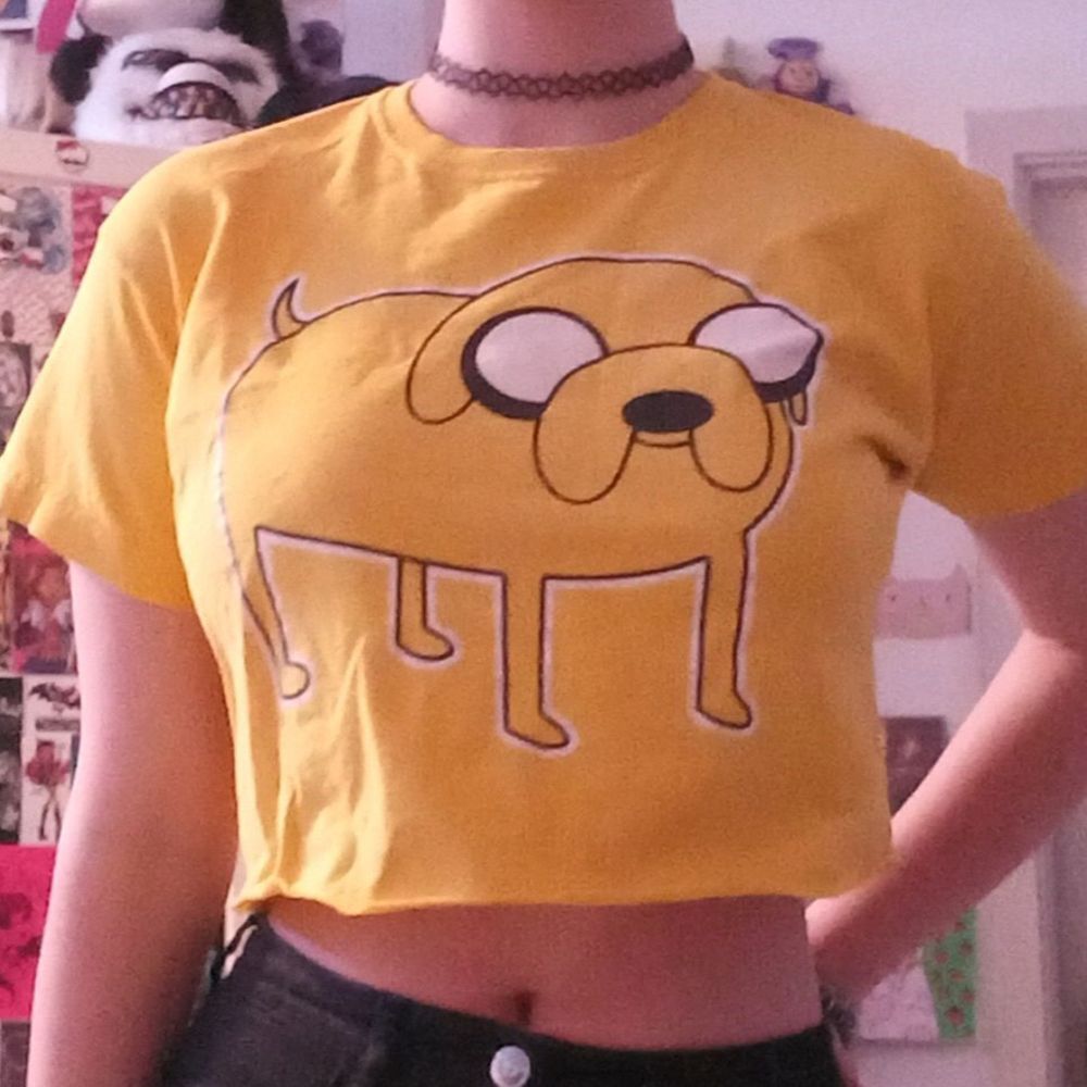 T-shirt från Fruit of the loom med Jake från Äventyrsdags som jag klippt till en magtröja. Knappt använd. Står inuti att det är storlek 140 men passar bra på en liten XS. Lite sprickor i trycket (se bild) men inga andra skador/fläckar. BETALNINGSMETOD: SWISH (PÄLSDJUR I HEMMET). T-shirts.