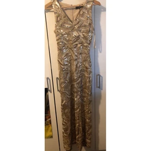 Festklänning från Sisters point - Festklänning i Guld med split vid knät, Sitter jätte snyggt i midjan och vid urringning. Köparen står för frakten säljs för 500 eller ge bud