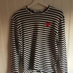 COMME des GARCONS PLAY    M - Säljer en sparsamt använd COMME des GARCONS långärmad T-shirt, då den inte används. Plagget är i storlek M, men jag själv skulle säga att den är närmare storlek S.