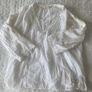 Vit blus från Odd Molly  - Jättesöt vit blus från Odd Molly med många coola mönster och detaljer. Den har ett fint flow med trekvarts ärmar. Toppen har mycket coola detaljer på ärmarna. Passar perfekt till ett par jeans eller en fin kjol. Hittar tyvärr inte storlek men skulle säga att den passar som en M.