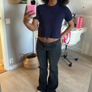 Mörkblå croppad tröja - Säljer en mörkblå croppad tröja med korta ärmar. Perfekt för en avslappnad stil. Tröjan har en enkel design och är lätt att matcha med olika outfits.