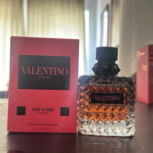 Valentino Donna Born In Roma Intense - Lyxig parfym med elegant, diamantmönstrad glasflaska i bärnstensfärg och svart kork. Kommer i snygg rosa och svart förpackning. Doften är intensiv och feminin, perfekt för dig som vill sticka ut med en modern och djärv signatur.