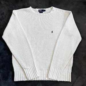 Ralph Lauren stickad tröja  - Säljer en klassisk vit stickad tröja från Polo Ralph Lauren i 100% bomull. Storlek L, skick 7/10 finns någon fläck annars bra skick. Pris går att diskutera✅