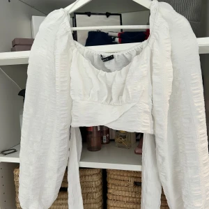 Vit blus med knytband - Säljer en vit blus med band man knyter vid ryggen. 