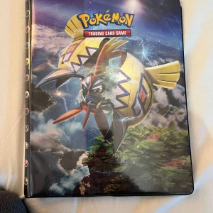 Pokémon samlarkortpärm med kort - Säljer en Pokémon samlarkortpärm med motiv av Tapu Koko och Alolan Ninetales på omslaget. Pärmen innehåller flera Pokémonkort, bland annat Swablu, Stufful, Lillipup och Jigglypuff. Perfekt för dig som vill samla eller organisera dina Pokémonkort.