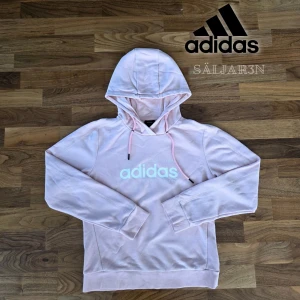 Ljusrosa hoodie från Adidas - Adidas hoodie i damstorlek S, ljusrosa. Mjuk och bekväm – perfekt för vardag, träning eller mys! Vit Adidas-logga, normal passform med justerbar huva och muddar. I mycket fint skick, knappt använd och utan skador eller fläckar. Snabb leverans – skickas samma dag! Kontakta mig vid intresse. #Adidas #Hoodie #RosaHoodie #Damkläder #Secondhand #Streetwear #Mode #Säljes  
