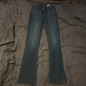 Lee Breese Bootcut jeans mörkblå - Snygga mörkblå bootcut jeans från Lee, modell Breese Boot. Klassisk femficksdesign, normal passform och tillverkade i mjukt denimtyg. Perfekta för dig som gillar en tidlös look med lite utsvängda ben.
