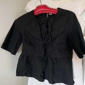 Svart blus med knyt från H&M - Svart blus från H&M med knytning. Använt 2 gånger 