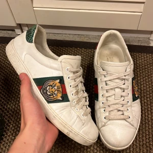 Gucci ace - Tjena säljer mina Gucci ace med en fet tiger deign. Dom är i mycket fint skick och dom är i storlek 41 passar 40 också. Inget og följer med dom är 100% äkta det är bara att höra av dig vid minsta frågan😃