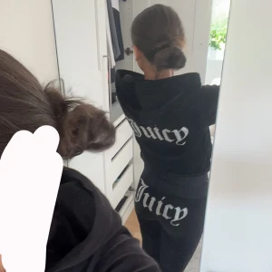 Svarta Juicy Couture sett - Svarta mjukisbyxor från Juicy Couture i mjuk sammet med glittrig Juicy-text baktill. Byxorna har normal passform, dragsko i midjan och raka ben. Perfekta för en chill och trendig look.