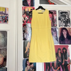 Fin gul 60-tals inspirerad klänning  - Jättefin klänning från Randiga Rutan, gissar att den är från 90-talet men med en liten inspo av 60-talet. I fint skick. Storlek saknas men tror den skulle passa någon i 34, men mäter gärna om man säger till. Jag kan mötas upp i Uddevalla centrum, annars fraktar jag gärna. Köparen står för frakten. (Står ej för postens slarv) katt finns i hemmet. 