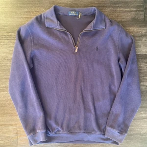 Mörkblå quarter zip Polo Ralph Lauren  - Säljer en mörkblå quarter zip från märket polo Ralph Lauren. Tröjan är i storlek L men borde passa m också. Kappan där storleken står har dock gått sönder se sista bilden. Annars är tröjan i relativt fin skick. Skriv vid funderingar eller diskution kring pris😊