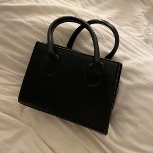 Svart handväska med dragkedja - får med axelrem