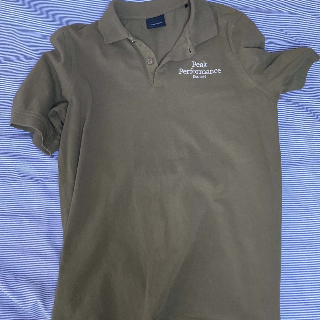 Olivgrön pikétröja från Peak Performance