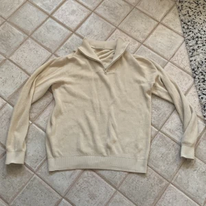 Beige ribbad tröja från Kappahl - Säljer en stilren beige ribbad tröja från Kappahl med dragkedja vid halsen. Tröjan har långa ärmar och en bekväm passform, perfekt för kyligare dagar. Passar både till vardags och mer avslappnade tillfällen.