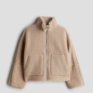  teddyjacka  - Mysig beige teddyjacka med dragkedja och stora fickor framtill. knappt använd