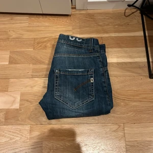 Blå jeans från Dondup - Snygga blå jeans från Dondup med klassisk femficksdesign och kontrastsömmar. De har en rak passform och är perfekta för en avslappnad och klassisk stil. Märkeslogga på insidan av linningen. 