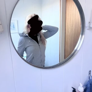 Grå huvtröja med dragkedja Polo Ralph Lauren - Säljer en stilren grå huvtröja från Polo Ralph Lauren. Tröjan har en dragkedja framtill och en liten logotyp på bröstet. Perfekt för en avslappnad look. Använd två gånger. 