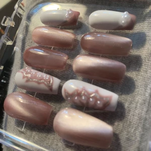Gele naglar - Snyggt set av gele naglar med cat eye effekt och vita detaljer. Allt som behövs för att sätta fast naglarna följer med!