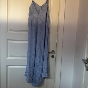 Ljusblå långklänning från Object - Säljer en vacker ljusblå långklänning från Object. Klänningen har en v-ringad design och smala axelband, perfekt för sommarens varma dagar. Materialet är lätt och luftigt, vilket gör den bekväm att bära. Passar utmärkt för en avslappnad och stilren look.
