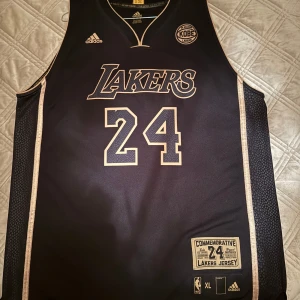 Limited edition Kobe Bryant authentic Jersey (24 collection) - Very rare Kobe Bryant Jersey that could only be bought at Staples Center if you were at his last game of his career on April 13, 2016.   This masterpiece was created by Adidas and the NBA as a thank you for Kobe Bryant's legendary 20 years of excellence, perfection and many memories that can't fit in a Line but they did it as best they could. Black/snakeskin and gold symbolizing ”The Black Mamba” and Kobe it was all about winning. Inside the jersey is engraved all his achievements and records.
