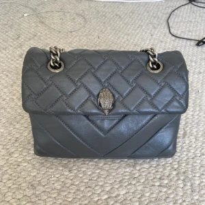 Grå/grön Kurt Geiger väska  - Snygg Kurt geiger axelväska som är slutsåld och skit snygg! Den är använd och har vissa defekter undertill, kom privat ifall du vill ha bild på det! Praktisk
