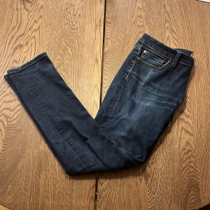 Mörkblå jeans med stretch - Snygga mörkblå jeans med en slim passform och stretch för extra komfort. Klassisk design med fem fickor och en diskret tvätt för en stilren look. Perfekta för en avslappnad stil. Passar dem som har 32-33 i bredd och dem som har 30-32 i längd