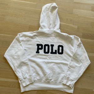 Vitt Ralph lauren hoodie - Säljer en stilren vitt Ralph lauren hoodie. I storlek large i barn storlek den passar typ som en xs. Perfekt för sommaren/våren med den vita färgen. Den har en snygg mörkblå design i bak.