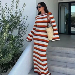 Randig långklänning med öppen rygg - Superfin långklänning i stickat material med vågiga ränder i vitt, brunt, orange. Klänningen har lång ärm, figurnära passform och en djup öppen rygg som ger en snygg twist. Perfekt för sommarens alla tillfällen!