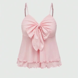 Ljusrosa linne  - Supersöt ljusrosa topp med rosett. Justerbara smala axelband. Perfekt för sommardagar.