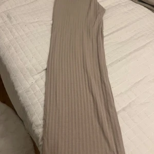 Beige ribbade byxor - Säljer ett par beige ribbade byxor med raka ben och stretchigt material. Perfekta för en avslappnad och trendig stil. Byxorna har en mjuk känsla och passar bra till många olika outfits.