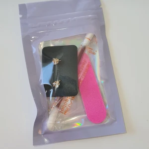 Skönhets kit - Snygga guld&silvriga örhängen med skimrande stenar. Perfekta för att ge en touch av elegans till din outfit. Inkluderar även en rosa nagelfil och en rengöringspinne av sår.