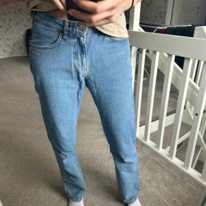 Blå jeansbyxor - Säljer ett par klassiska blå jeansbyxor med normal passform. De har en rak stil och är tillverkade i jeansmaterial. Perfekta för en avslappnad look.