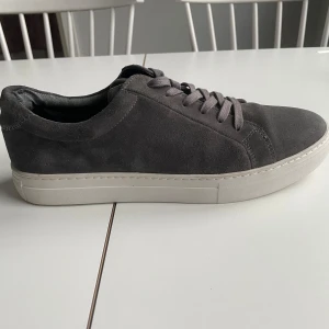Grå sneakers från Vagabond - Säljer dessa supersnygga herrskor från Vagabond i mocka! Passar till alla outfits och alla årstider! ☀️   Skicket är i princip helt perfekt, använd endast 2 gånger.   Märke: Vagabond  Storlek: 42 EU (herr), passar 42, 43. Färg: Grå Nypris: 1400 sek  Innersulan går inte att ta ut. 