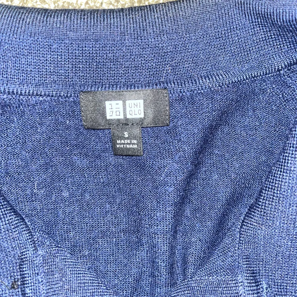 Säljer en stilren mörkblå pikétröja från Uniqlo. Tröjan har en klassisk krage med två knappar och långa ärmar. Perfekt för en avslappnad men ändå snygg look.. Neuletakit & Villapaidat.