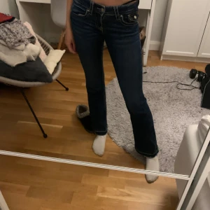 Mörkblå bootcut jeans med låg midja  - Säljer ett par mörkblå jeans med bootcut passform. Klassisk femficksmodell med låg midja och snygga kontrastsömmar. Storlek 152 men passar en xxs. Uppsprättade längst ned och nu är dem något korta på mig som är 168 cm lång. Passar nog någon runt 165 cm