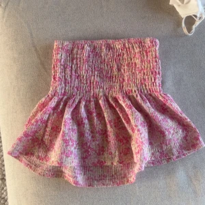 Rosa blommig volangtopp - Supersöt topp med blommigt mönster i rosa och vitt. Finns även band till axlarna!💕