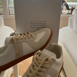 Maison Margiela gats - Tja tja! Säljer nu dessa feta eftertraktade par Maison margeila gats i den originella vita färgen✌️Köpte hem dessa nyligen men de passade tyvvär inte. Skulle rekommendera att gå en halv storlek upp!Såklart har jag kvitto till dessa o det är bara att skriva i dm vid fundering osv. Storlek 43| Inga skam bud! Men såklart är priser ej hugget i sten!😎