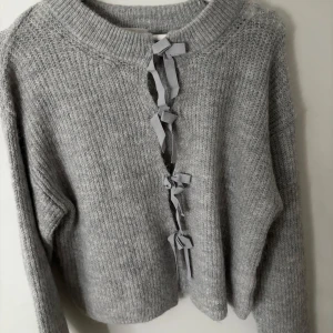 Grå stickad kofta med snörning Gina Tricot - Köpte den nyss men använder inte aldrig suttit på mig den. Men den är så fin på. Väldigt mysig 