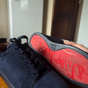 Christian Louboutin - Säljer ett par mörkblå sneakers från Christian Louboutin. Har haft den snart ett år men använd inte så ofta. Kvitto , påsar och box finns. 