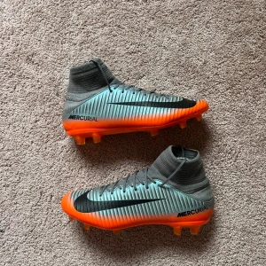 Nike Mercurial superfly V CR7  - Säljer ett par Nike Mercurial fotbollsskor med högt skaft i grått och orange.   KOM GÄRNA MED BUD !!!