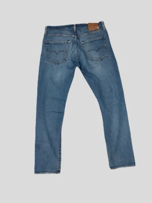 Levis 502  - Snygga tvättade Levi’s 502 (W32 L32). Skön modell med lite mer plats upptill och avsmalnande ben. Mjuka och ingångna i tyget. Obs: Har en liten defekt i form av ett litet hål på vänster sida vid låret, i övrigt i fint skick. 