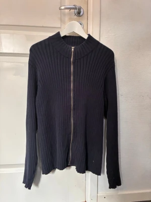 Marinblå ribbad ziptröja Tommy Hilfiger - Säljer denna Tommy hilfiger tröja i storlek M, sitter bra på de som är 180+ och med lite muskler.