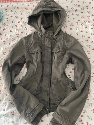 American Eagle vintage jacka - Säljer denna superfina khaki/gråa vintage jackan från American Eagle i storlek S. Jackan är i mycket fint skick. Luvan är avtagbar. För fler bilder eller frågor är det bara att höra av sig 💕 Vid snabb affär kan pris alltid diskuteras!🙌🏼💕