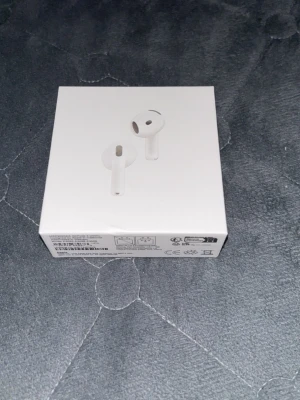 Apple AirPods 4 ANC trådlösa hörlurar - Säljer ett par vita Apple AirPods 4 med aktiv brusreducering (ANC). Snygg och stilren design i plast, levereras i originalförpackning. Perfekta för musik, poddar och samtal med trådlös frihet och enkel anslutning till Apple-enheter.