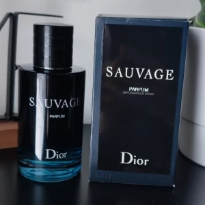 Dior Sauvage Parfum 100ml - Dior Sauvage. Parfum. 100ml. Used a bit, please see picture for the amount left. Its still a lot left in the bottle! The bottle has unfortunately defects. Where the sprayer part meets the bottle, it sits abnormal on one side. You can use it as normal! The caps initials has also almost fully gotten scratches away and some scratches on the front text. The box has a lot of bumps and scratches, I can send it with the perfume if you want it. Please contact me and I will send you more pictures