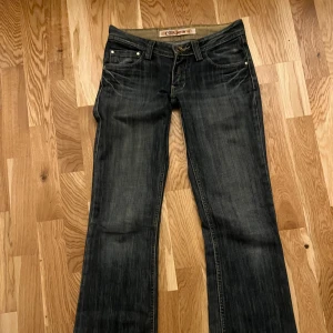Mörkblå jeans från C1B - Snygga mörkblå jeans från C1B med bootcut-stil. De har en klassisk femficksdesign och dekorativa sömmar på bakfickorna. Perfekta för en avslappnad look. Lite mindre då de är insydda för lägre midja skitsnygga