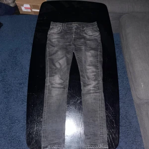 Nudie Jeans - Mörk grå - PRISET ÄR DISKUTERBART Säljer nu mina nudie jeans då de inte kommer till någon använding. Skick 9/10 använd fåtal gånger. Nypris 1600kr - Storlek 29/32