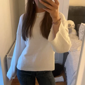 Vit stickad tröja - Säljer en stilren vit stickad tröja med långa ärmar. Perfekt för kyligare dagar och enkel att matcha med olika outfits. Sparsamt använd, inga defekter